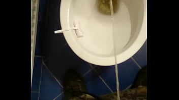 Guy pissing in toilet