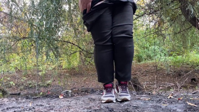 MILF dressed in pants pissing in public outdoors
