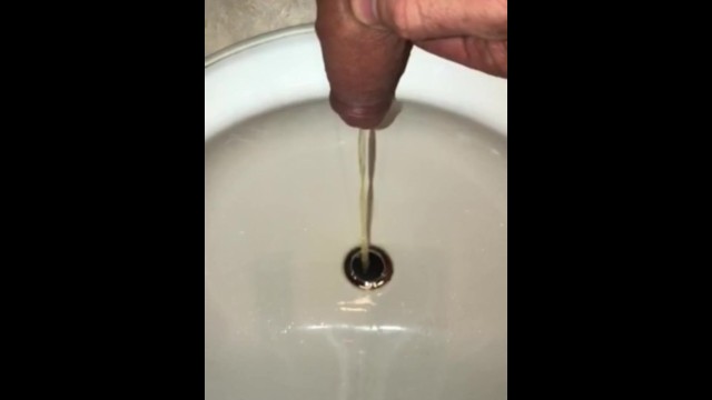 Pissing In The Bathroom Sink Using The Drain As A Target