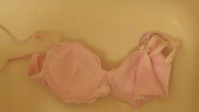 pissing on cup of pink bra!