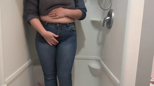 Naughty girl desperately pisses jeans in shower