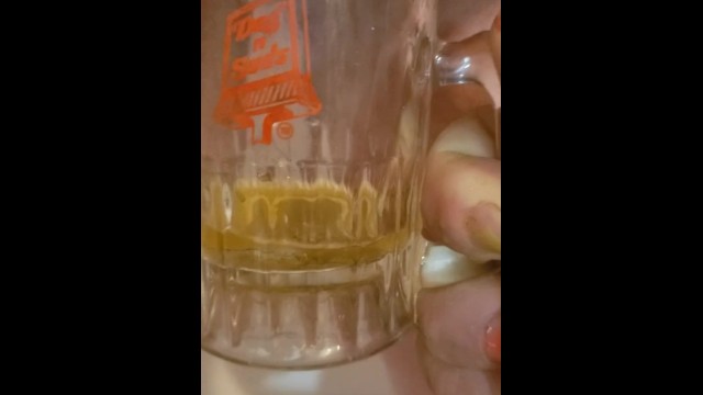 Bbw encouraged to pee more into glass