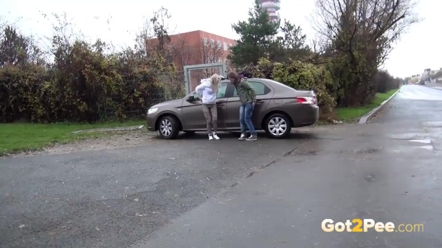 Blonde And Brunette Squat And Piss Together