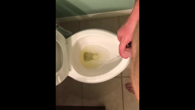 Taking a long Pee in the toilet.