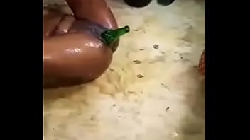 Teen inserts a bottle in her pussy in public