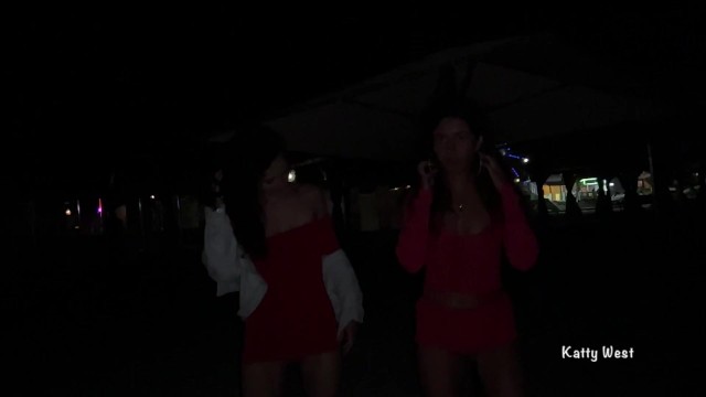 Two girls pissing on a public promenade on the beach